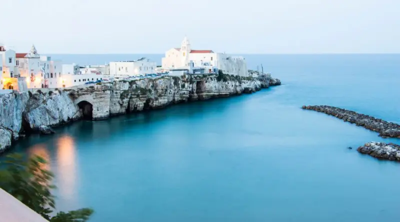 Beautiful seaside town of Vieste, Italy with a cliffside view and clear blue waters.