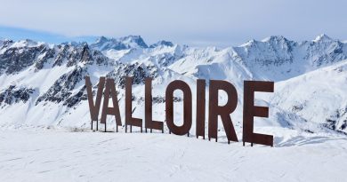 Large valloire sign in a snowy mountain landscape