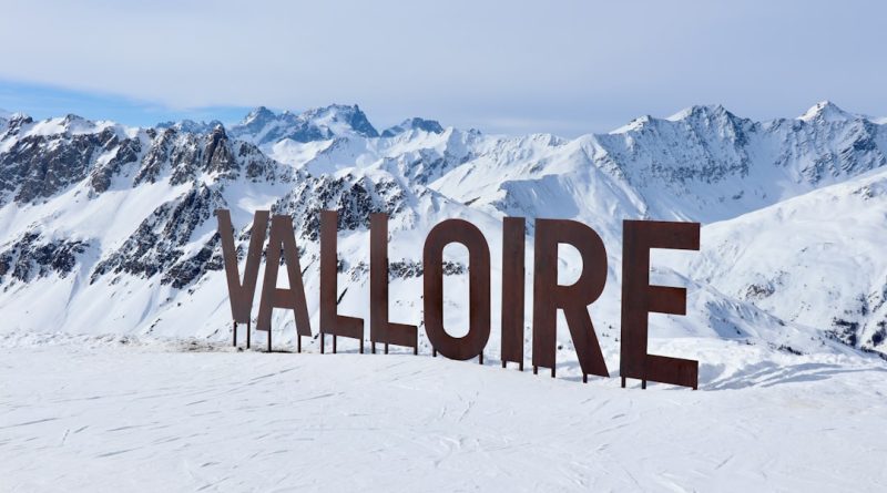 Large valloire sign in a snowy mountain landscape