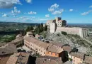 A stunning aerial view of the historic Verucchio Castle in Emilia-Romagna, Italy, against a clear sky.