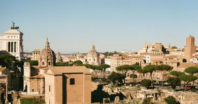 Explore the historic Roman Forum in Lazio, Italy, showcasing ancient architecture under a clear blue sky.