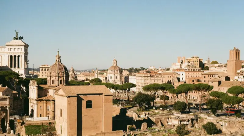 Explore the historic Roman Forum in Lazio, Italy, showcasing ancient architecture under a clear blue sky.