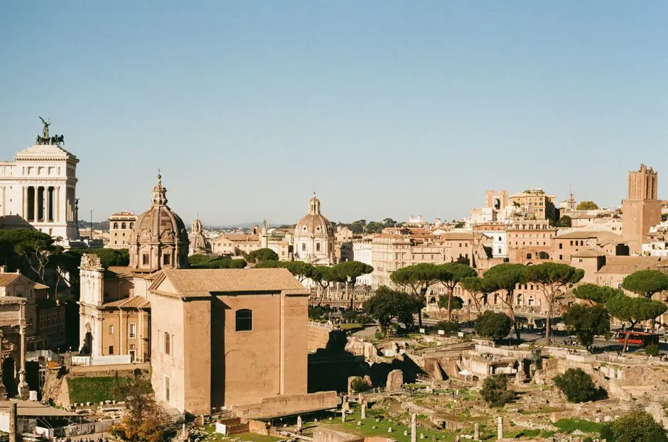 Explore the historic Roman Forum in Lazio, Italy, showcasing ancient architecture under a clear blue sky.